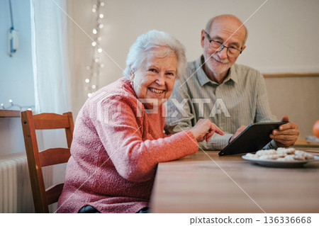Senior coule working with tablet, making reservation or shopping online. Senior coule working with tablet, making reservation or shopping online. 136336668