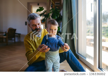 Father with little toddler son at home. Father with little toddler son at home. 136336802