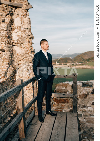 Full length shot of young groom in suit. Full length shot of young groom in suit. 136337010