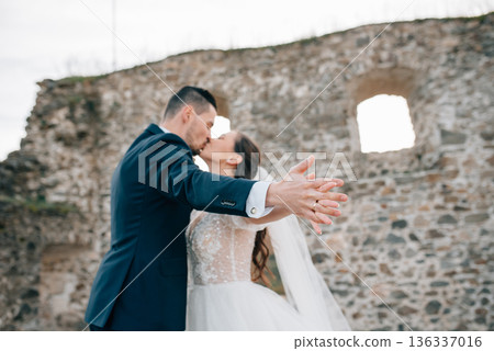 Portrait of husband kissing beautiful bride. Portrait of husband kissing beautiful bride. 136337016