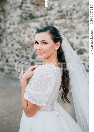 Stunning bride in a snow-white wedding dress with short sleeves. 136337116