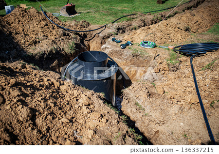 Installing underground utility shaft during construction work. 136337215