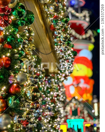 Festive Christmas Street Decorations With Shiny Ornaments And Lights At Night Festive Christmas Street Decorations With Shiny Ornaments And Lights At Night 136337269