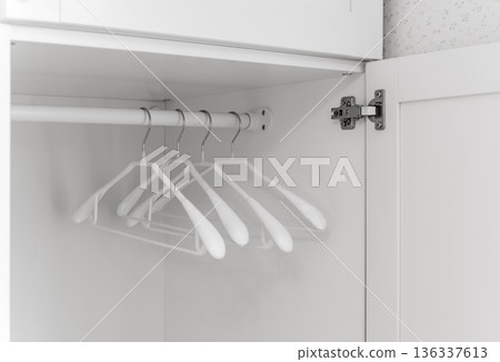 Open wardrobe with hangers Open wardrobe with hangers 136337613