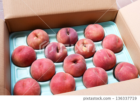 新鮮的桃子整齊地擺放在紙箱裡。 136337719