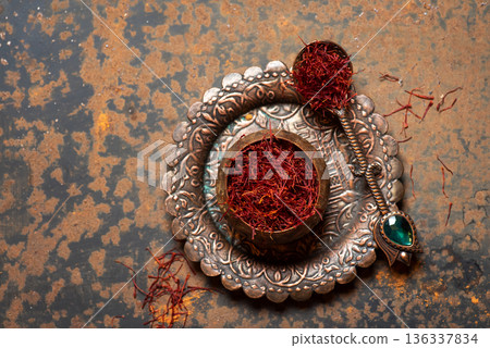 Vibrant Saffron Threads In An Ornate Bowl On Textured Surface 136337834