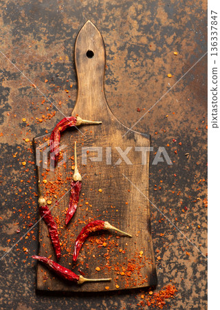 Vibrant Dried Chilies And Chili Powder On Rustic Cutting Board Vibrant Dried Chilies And Chili Powder On Rustic Cutting Board 136337847