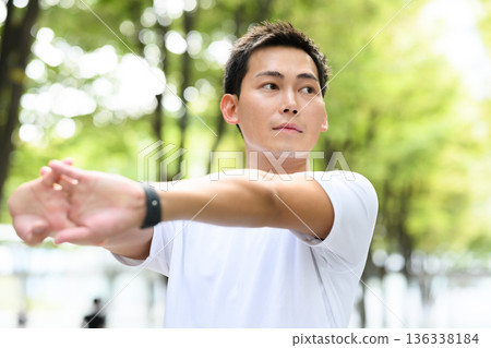 Man stretching his arms Man stretching his arms 136338184