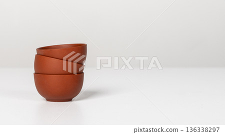 Stack of three small ceramic cups, bowls on table. Banner background with kitchen ware. Banner Stack of three small ceramic cups, bowls on table. Banner background with kitchen ware. Banner 136338297