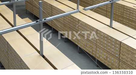 Top view of long rows of wooden card catalog cabinets inside a library or archive interior. order, Top view of long rows of wooden card catalog cabinets inside a library or archive interior. order, 136338310