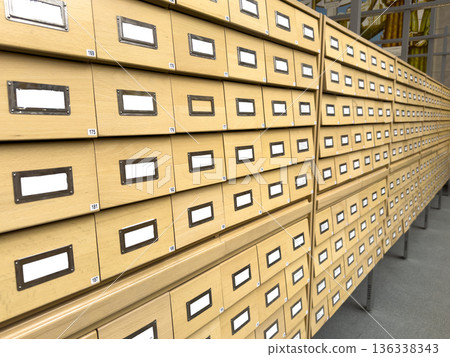Long rows of wooden card catalog drawers arranged in a repeating pattern inside an archive or 136338343