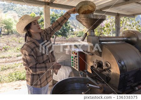 Coffee processing. Coffee roasting machine with arabica beans in stainless steel cooling bin. 136338375