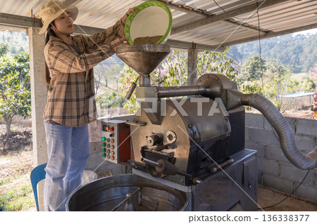 Coffee processing. Coffee roasting machine with arabica beans in stainless steel cooling bin. 136338377