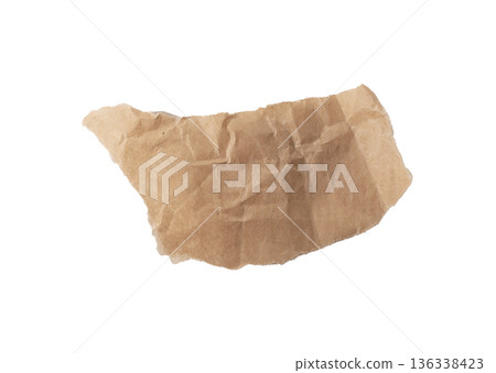 Torn brown kraft paper fragment with crumpled texture, rough teared edges, and organic uneven shape. Torn brown kraft paper fragment with crumpled texture, rough teared edges, and organic uneven shape. 136338423