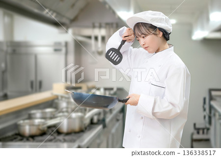 A woman making cooking A woman making cooking 136338517