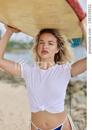 Relaxed Woman In Sunlit Setting. Calm Female Figure With Knotted Shirt Smiling On Warm Sunny Shore Relaxed Woman In Sunlit Setting. Calm Female Figure With Knotted Shirt Smiling On Warm Sunny Shore 136338932