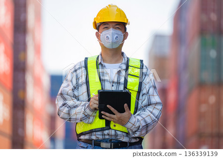 Foreman or worker work at Container cargo site check up goods in container. Foreman or worker work at Container cargo site check up goods in container. 136339139