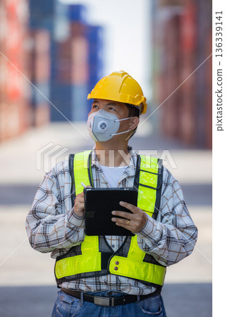 Foreman or worker work at Container cargo site check up goods in container. Foreman or worker work at Container cargo site check up goods in container. 136339141