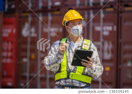 Foreman or worker work at Container cargo site check up goods in container. Foreman or worker work at Container cargo site check up goods in container. 136339145