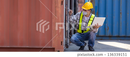 Foreman or worker work at Container cargo site check up goods in container.  136339151