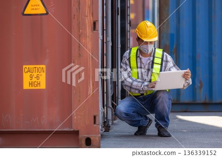Foreman or worker work at Container cargo site check up goods in container.  136339152
