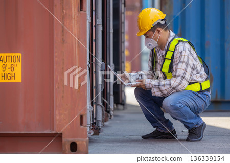 Foreman or worker work at Container cargo site check up goods in container.  136339154