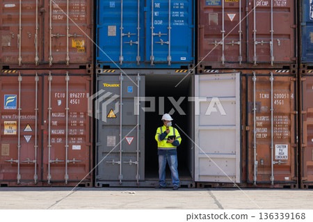 Foreman or worker work at Container cargo site check up goods in container.  136339168