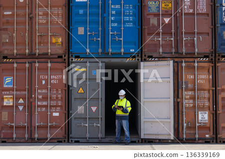 Foreman or worker work at Container cargo site check up goods in container.  136339169