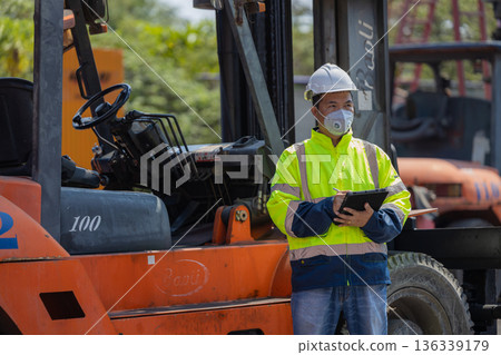 Foreman or worker work at Container cargo site check up goods in container. Foreman or worker work at Container cargo site check up goods in container. 136339179