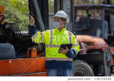 Foreman or worker work at Container cargo site check up goods in container. Foreman or worker work at Container cargo site check up goods in container. 136339180