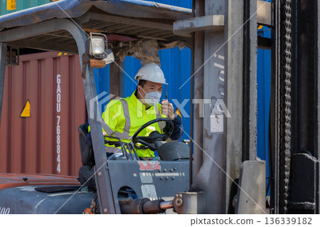 Foreman or worker work at Container cargo site check up goods in container. Foreman or worker work at Container cargo site check up goods in container. 136339182