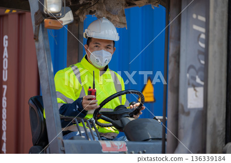 Foreman or worker work at Container cargo site check up goods in container. Foreman or worker work at Container cargo site check up goods in container. 136339184