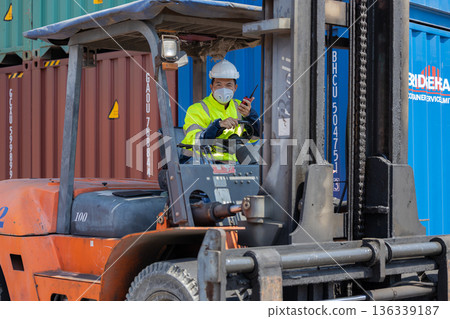 Foreman or worker work at Container cargo site check up goods in container. Foreman or worker work at Container cargo site check up goods in container. 136339187