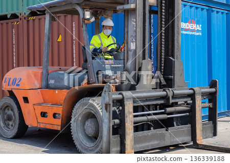 Foreman or worker work at Container cargo site check up goods in container.  136339188