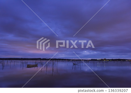 Morning glow reflected on the water surface Morning glow reflected on the water surface 136339207