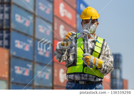 Foreman or worker work at Container cargo site check up goods in container. 136339298