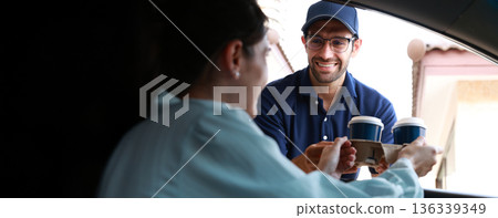 Hand Man in car receiving coffee in drive thru fast food restaurant. Hand Man in car receiving coffee in drive thru fast food restaurant. 136339349
