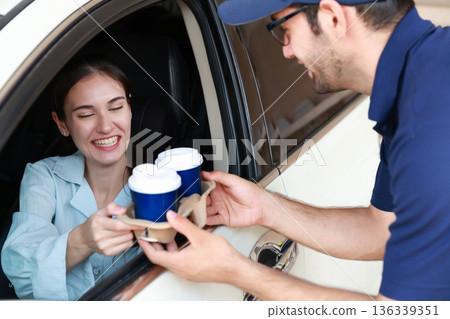Hand Man in car receiving coffee in drive thru fast food restaurant. Hand Man in car receiving coffee in drive thru fast food restaurant. 136339351