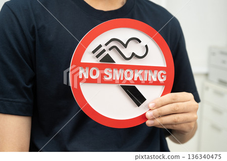 Male holding a no smoking sign. Male holding a no smoking sign. 136340475