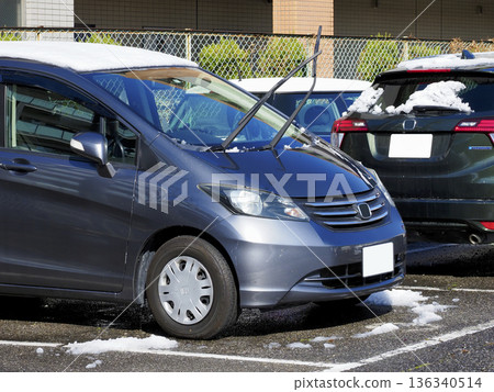 A car with its wipers up during snowfall A car with its wipers up during snowfall 136340514