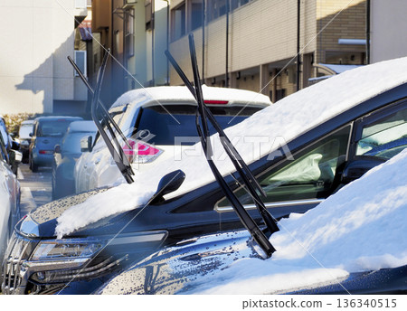 A car with its wipers up during snowfall A car with its wipers up during snowfall 136340515