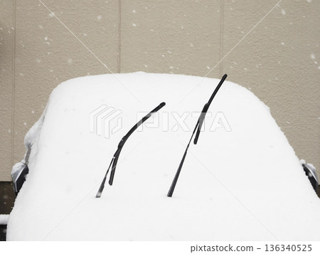 A car with its wipers up during snowfall A car with its wipers up during snowfall 136340525