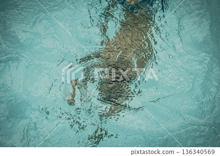 Abstract photo lifestyle, nature background. Unrecognizable person body deep under water, look at surface. Mystery mood. Concept of weightless, uncertain future, drown in obscurity, childhood issues Abstract photo lifestyle, nature background. Unrecognizable person body deep under water, look at surface. Mystery mood. Concept of weightless, uncertain future, drown in obscurity, childhood issues 136340569