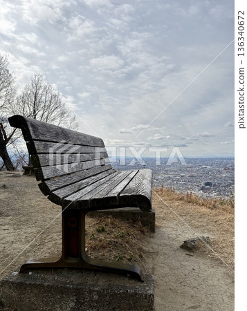 Wooden bench on a mountain observation deck 136340672