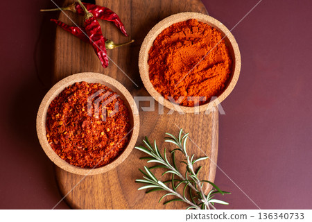 Colorful Chili Powder And Dried Red Chilies On Wooden Surface 136340733