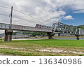 A train crossing the Ota River flood control bridge A train crossing the Ota River flood control bridge 136340986