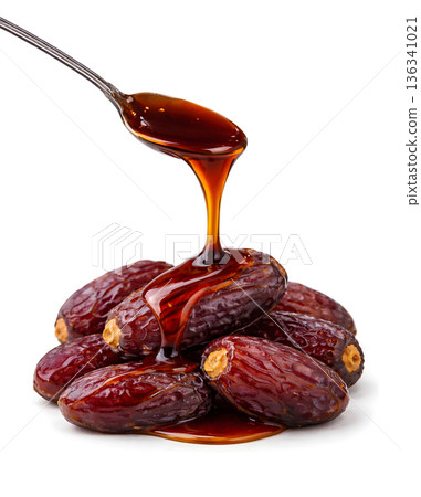 Pure date syrup flowing over premium whole dates Pure date syrup flowing over premium whole dates 136341021