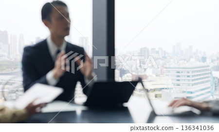 Blurred image of a group of business people having a meeting in an office 136341036