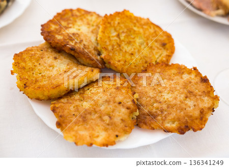 Potato pancakes with sour cream on white plate 136341249
