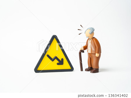 An elderly man with a cane and a downward-pointing arrow sign. A decline in benefits and living standards for the elderly and pensioners. Social support concerns drive policy debate. 136341402